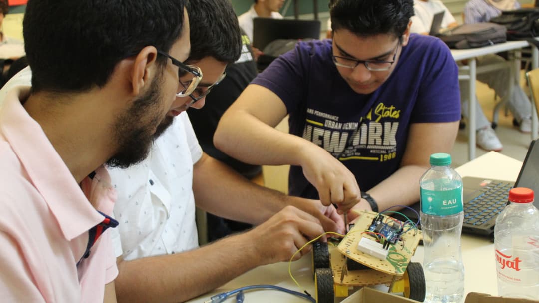 Students building a line-follower car.